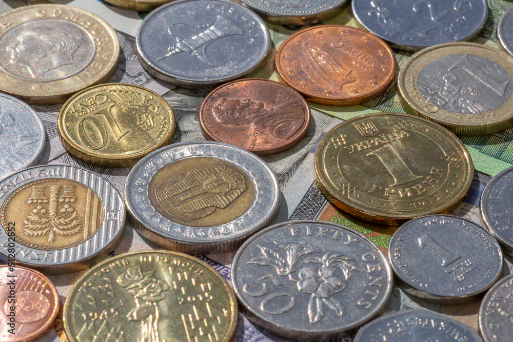 different currencies coins lying on paper banknontes different currencies coins lying on paper banknontes