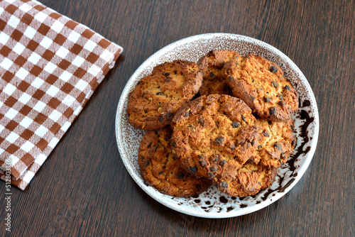 american cookies on plate on dark wooden background, close-up