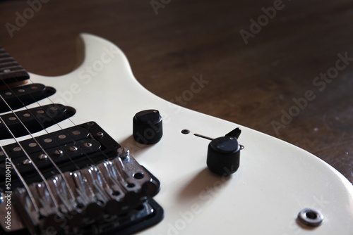 Tone and volume controls guitar on old wood surface