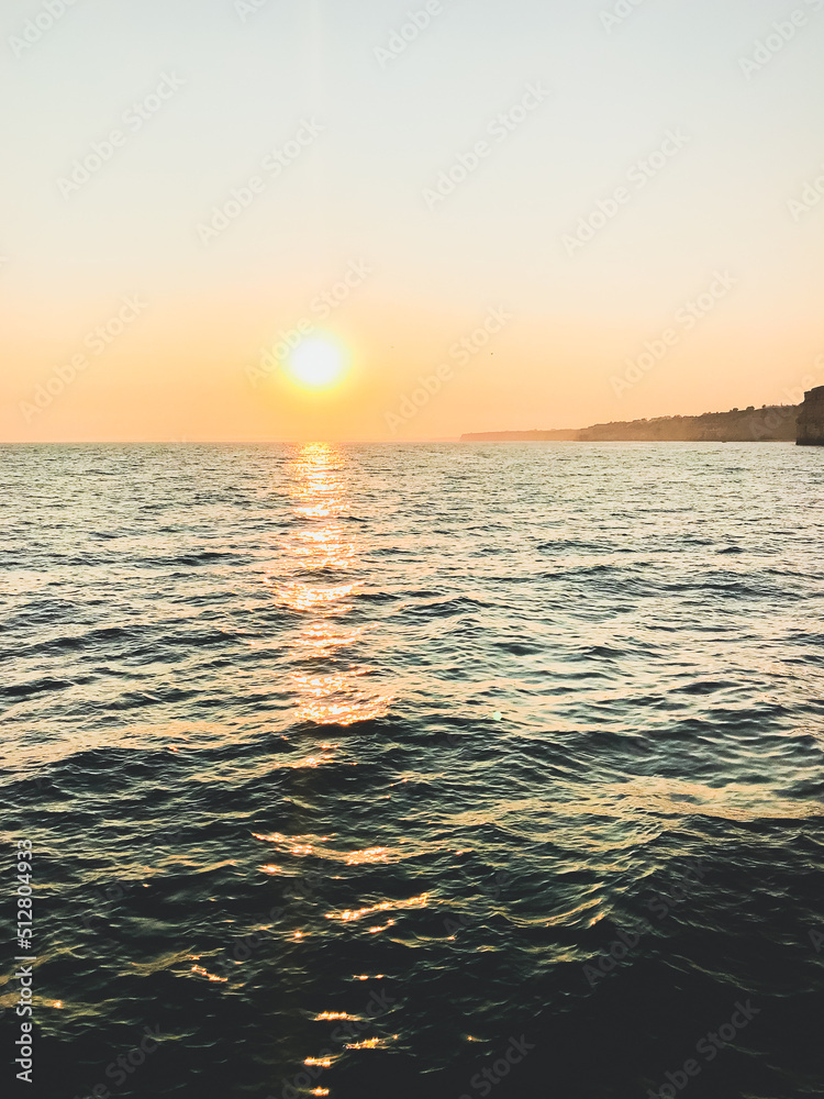 Fototapeta premium beautiful summer vacation sunset background and reflection over the sea and waves