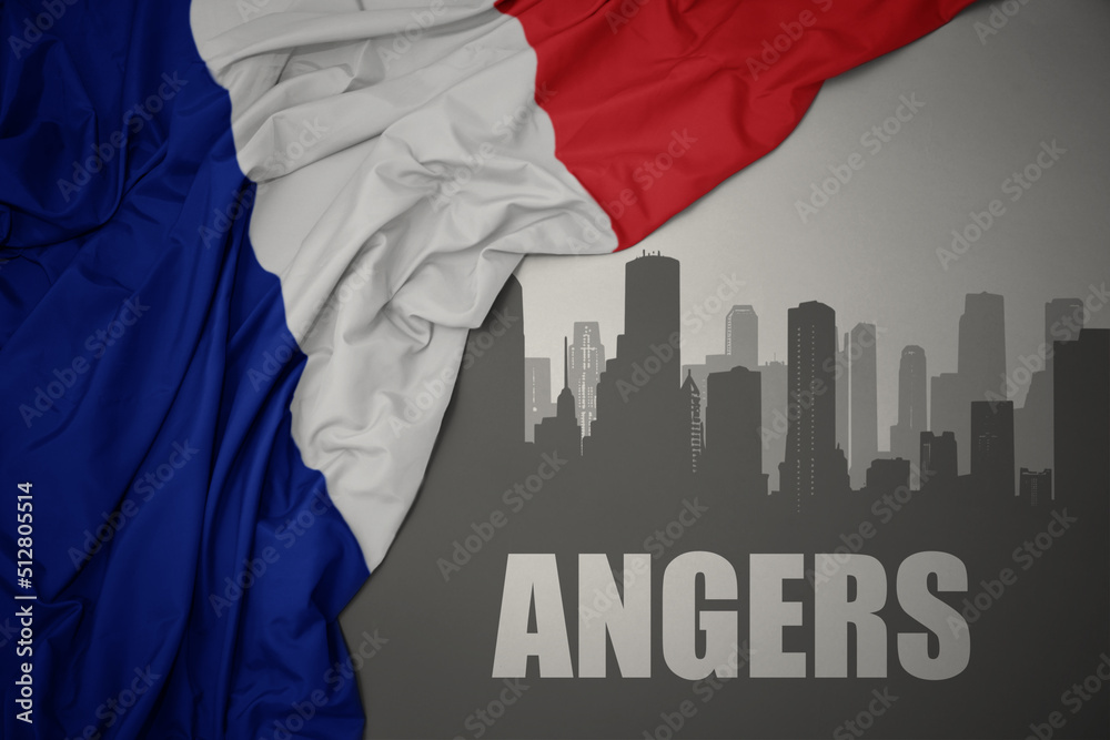 abstract silhouette of the city with text Angers near waving national flag of france on a gray background.