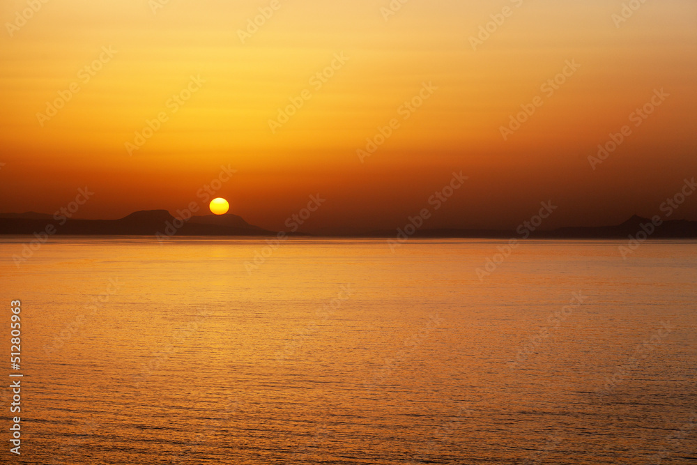 Beautiful colorful sunset over sea in Crete island at Greece Beautiful colorful sunset over sea in Crete island at Greece