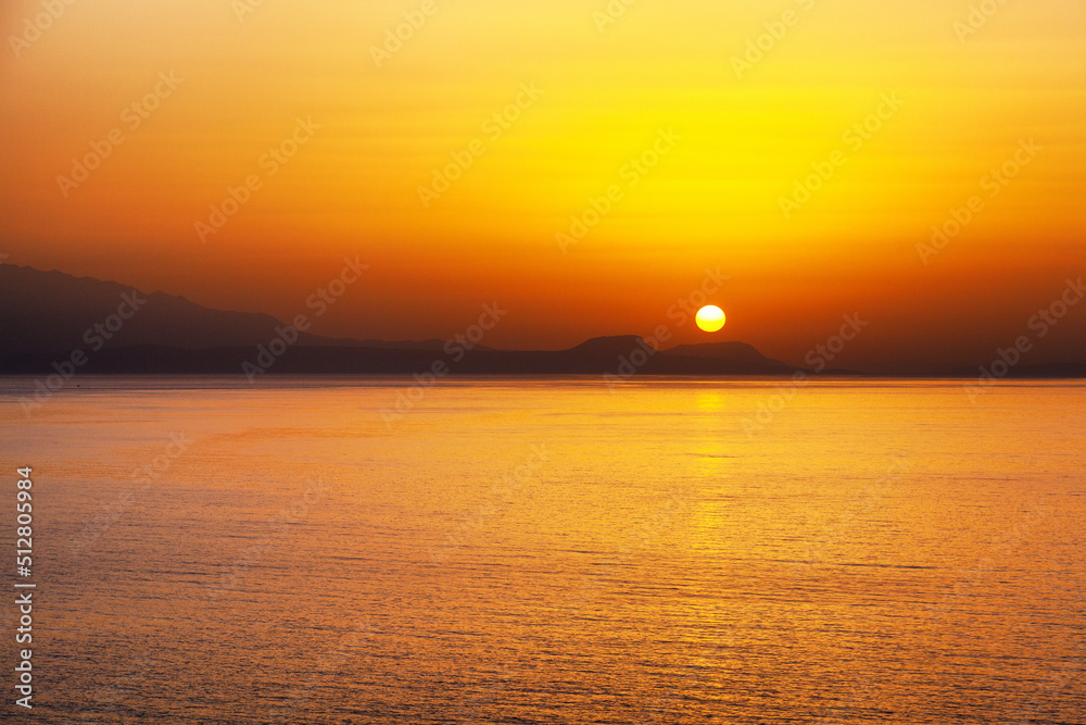 Beautiful colorful sunset over sea in Crete island at Greece