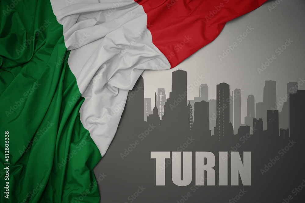 abstract silhouette of the city with text Turin near waving national flag of italy on a gray background.