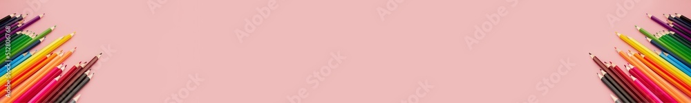 Fototapeta premium banner two group of multicolored watercolor pencils on pink background