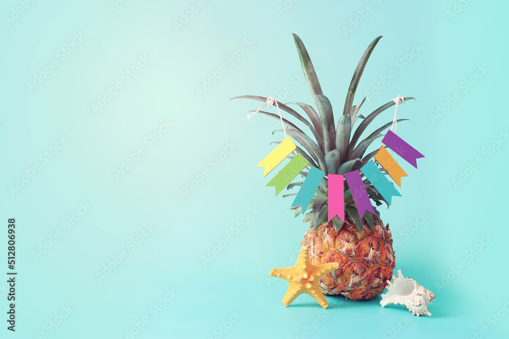 Image with ripe pineapple with parasol over blue background. Summer holidays and tropical theme