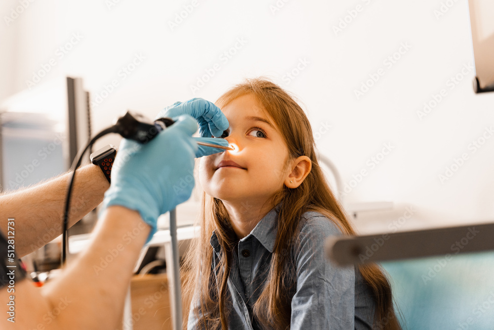 Nose endoscopy of child. Rhinoscopy procedure with rhinoscope. ENT doctor otolaryngologist with