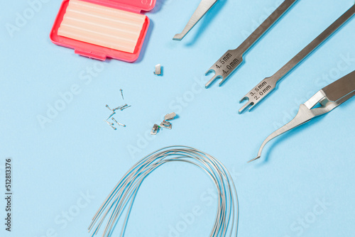 a set of special tools for an orthodontist to install braces for a patient. Orthodontic arcs, ligature, locks, positioner, tweezers photo