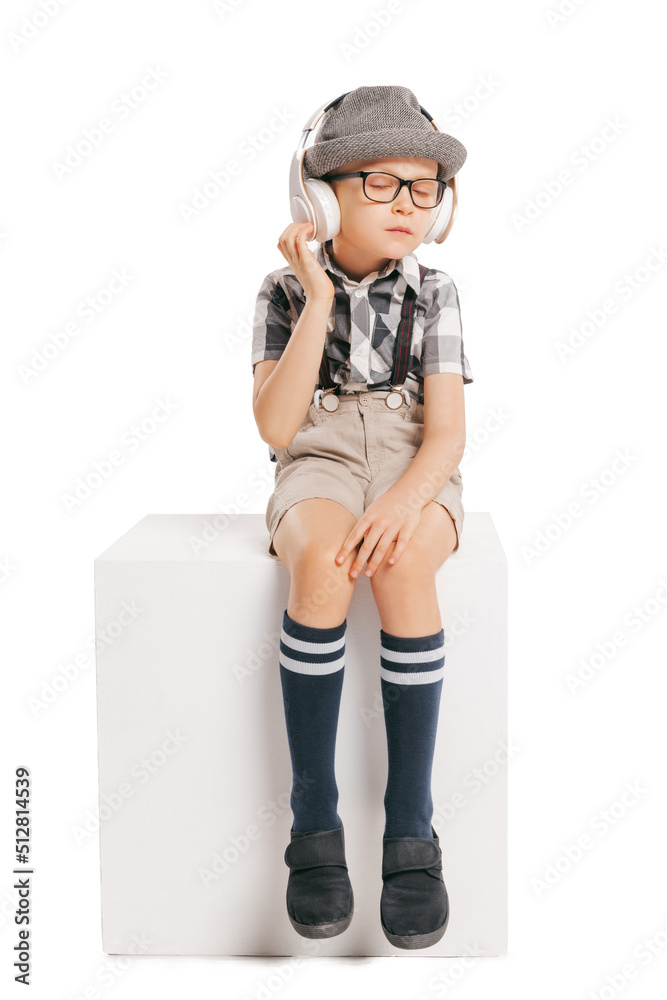 Portrait of cute little boy, happy kid in eyeglasses and hat isolated on white studio background with copyspace for ad. Retro vintage style concept Portrait of cute little boy, happy kid in eyeglasses and hat isolated on white studio background with copyspace for ad. Retro vintage style concept