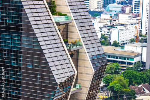 Pathum Wan District,Phloen Chit Road,Bangkok,Thailand on March 16,2019:close up the exterior of Rosewood Bangkok with a visually stunning,vertical architectural marvel.