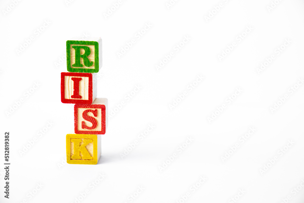 The word Risk spelled with a stack of colorful toy blocks The word Risk spelled with a stack of colorful toy blocks