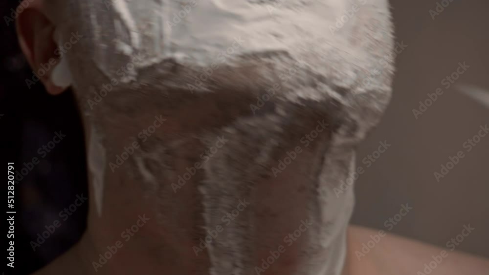 A person shaves with a razor, shaving foam is applied to the skin. Take care of the appearance, shave. Application of shaving foam A person shaves with a razor, shaving foam is applied to the skin. Take care of the appearance, shave. Application of shaving foam