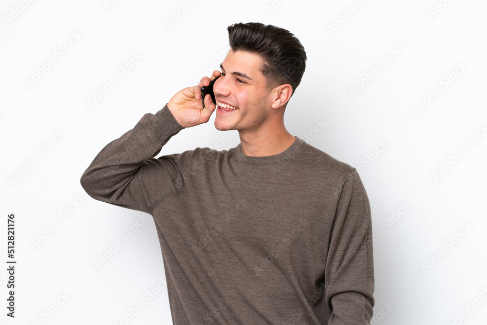 Young handsome caucasian man isolated on white bakcground keeping a conversation with the mobile phone Young handsome caucasian man isolated on white bakcground keeping a conversation with the mobile phone