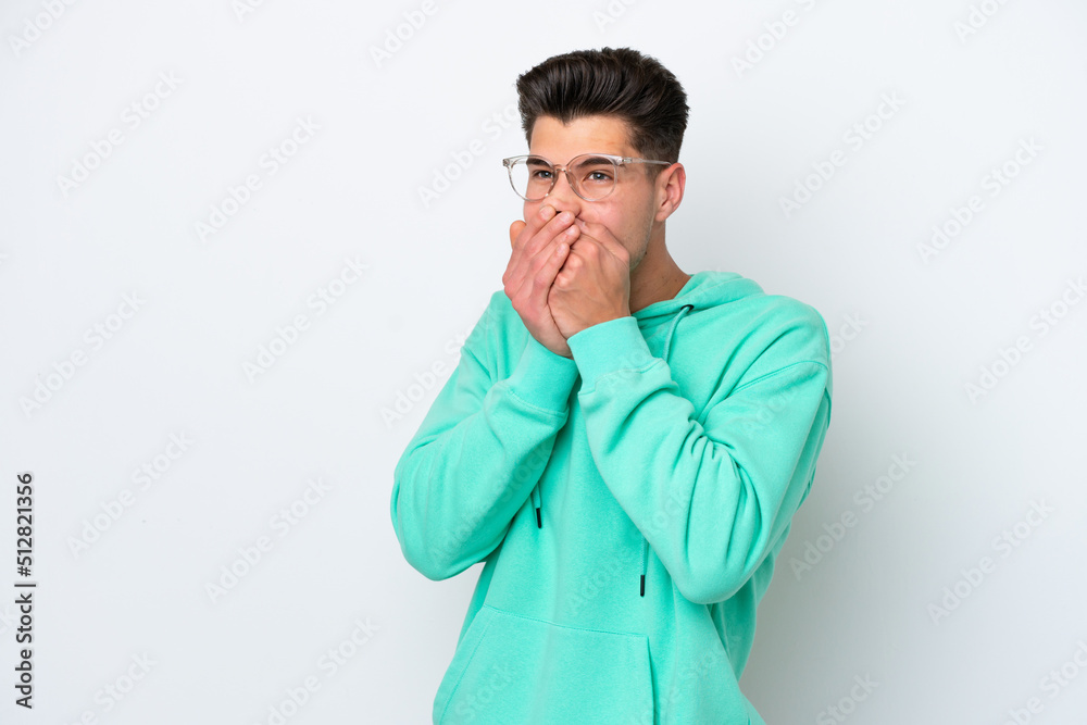 Young handsome caucasian man isolated on white bakcground covering mouth and looking to the side Young handsome caucasian man isolated on white bakcground covering mouth and looking to the side