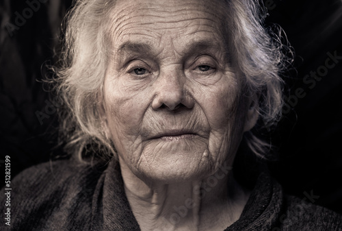 Portrait of beautiful elderly old woman in colorful bright lights blue and yellow, , 70s, grandmother, on black background., positive, smiling at camera, happy, studio, Close up, gray hair, caucasian