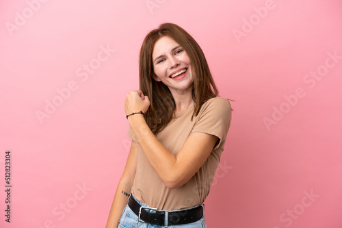 Young English woman isolated on pink background celebrating a victory © luismolinero