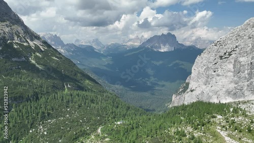 Hikers and travelers enjoying the beautiful mountain views as they have a mountain walk in the Dolomites Mountains, Italy. Active people in nature concept. photo