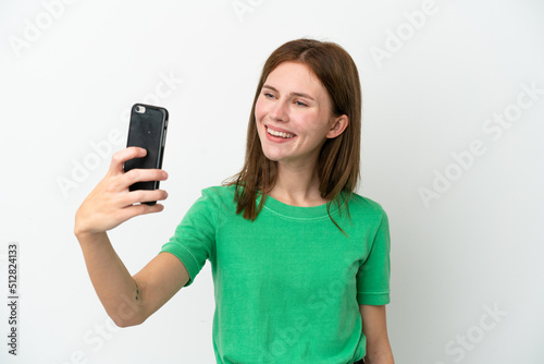 Young English woman isolated on white background making a selfie with mobile phone