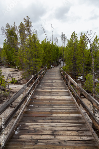 Boardwalk around Hot spring in American Landscape. Yellowstone National Park, Wyoming, United States. Nature Background.
