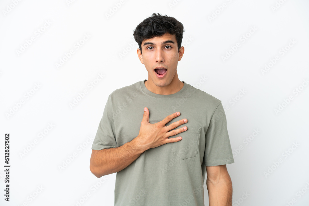 Young Argentinian man isolated on white background surprised and shocked while looking right Young Argentinian man isolated on white background surprised and shocked while looking right