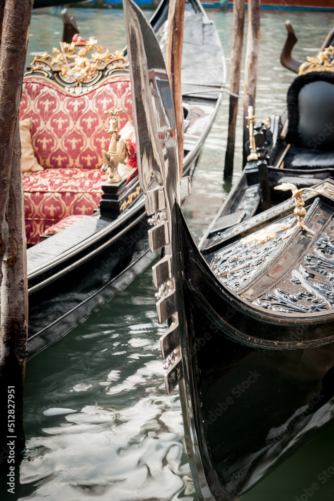 Venetian gondolas. Detail of the prow decoration of a pair of traditional gondolas on the Grand Canal in Venice, Italy.