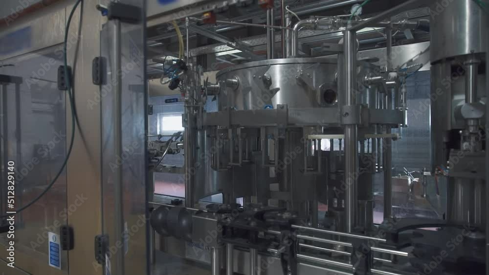 Industrial factory equipment used for production of alcoholic drinks. Modern industrial factory equipment on the production line. Automated industrial factory equipment manufacturing beverages. Industrial factory equipment used for production of alcoholic drinks. Modern industrial factory equipment on the production line. Automated industrial factory equipment manufacturing beverages.