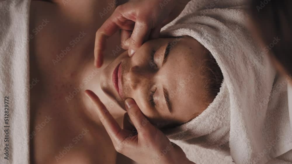 Beautician making facelifting massage at the beauty salon. Beautiful young girl. Body care. Cosmetic beauty spa salon. Beauty face.