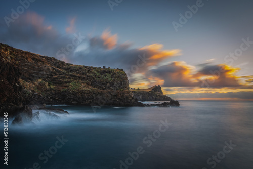 Coastline of Canico de Baixo and Reduto do Portinho rocks at sunrise. Madeira, october 2021. Long exposure picture
