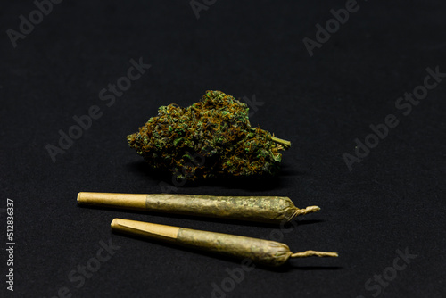 Dried flower marijuana and Pre-Rolls Cannabis Joints on a black background