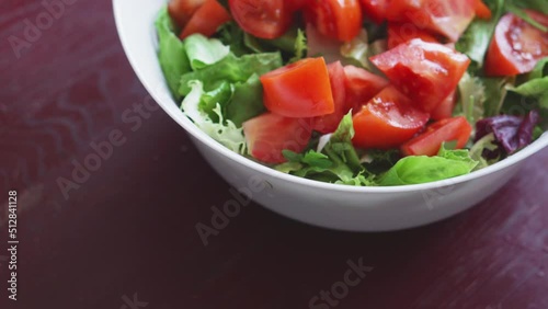 Wallpaper Mural Close up of healthy lunch with radishes, tomatoes, lettuce, aromatic herbs and olives. Cooking healthy food in the kitchen. Fresh vegetable salad. Vegetarian diet. Woman cuts and mixes salad. Torontodigital.ca