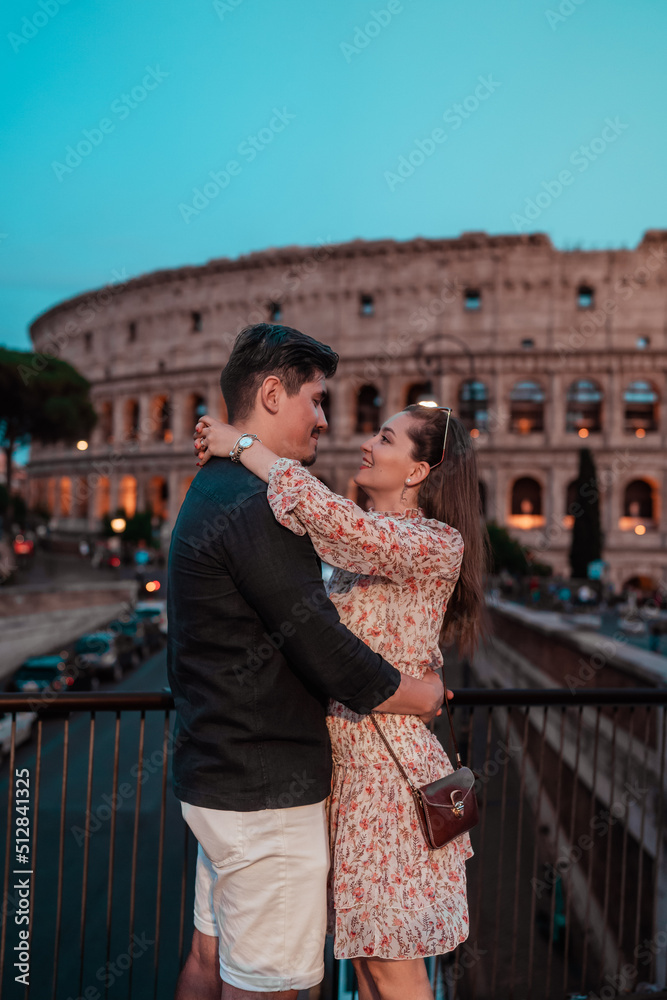 portrait of a couple in love in front of the roman colosseum