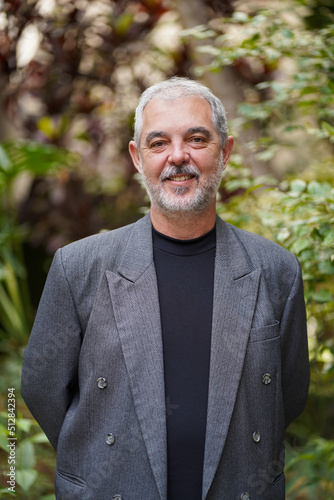 Senior professor in business suit smiling