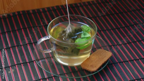 Dipping a tea bag in hot water cup