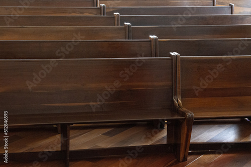 Empty side-by-side wooden pews in a church