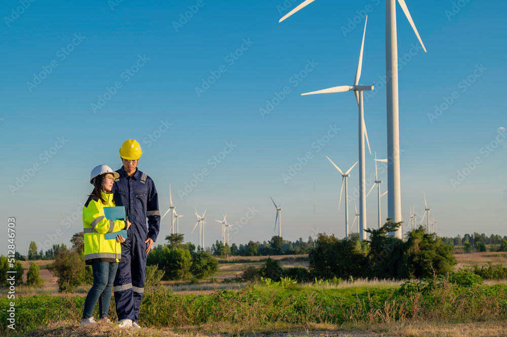 custom made wallpaper toronto digitalTwo engineers working and holding the report at wind turbine farm Power Generator Station on mountain,Thailand people,Technician man and woman discuss about work