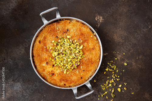 Traditional Arabian Kanafe with Cream and Cheese with pistachio nuts photo
