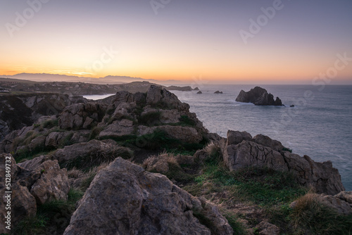 Beautiful landscape of the Cantabrian coast with the spectacular rock formations close to the shore of the coastline at sunset, Flysch and Urros at Costa Quebrada, Liencres, Cantabria, Spain
