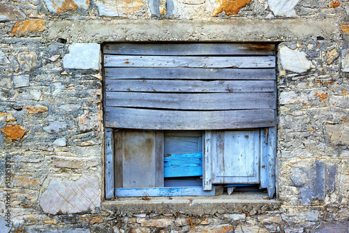 Closeup of an old wooden window on an ancient farmhouse. Historic casement and wall of a vintage or antique building. A tourism or sightseeing location to learn history and vintage architecture photo