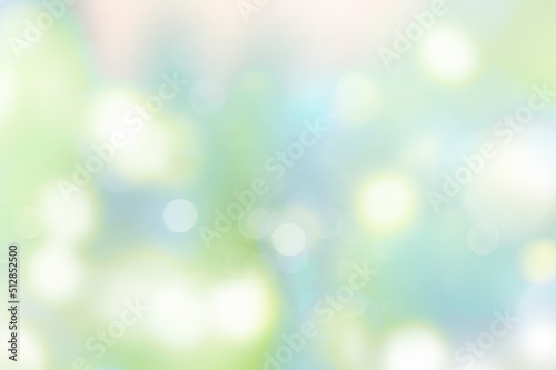 Spring blurred abstract background.Green blue glowing lights backdrop.