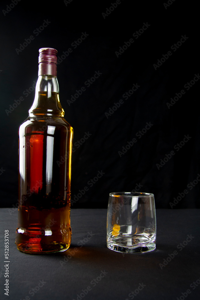 A strong amber whiskey on a black background. Scotch Whisky A strong amber whiskey on a black background. Scotch Whisky