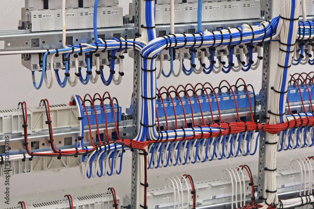 The reverse side of the electrical panel with connected wires with plastic ties.