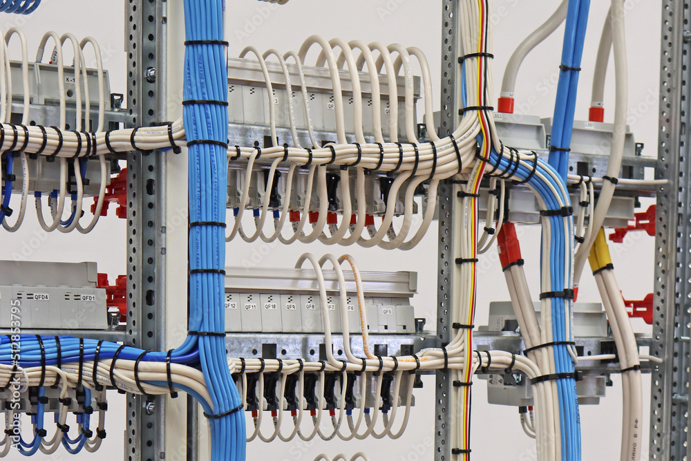 The reverse side of the electrical panel with connected wires with plastic ties.