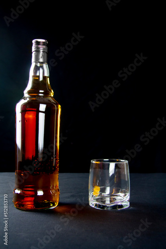 A strong amber whiskey on a black background. Scotch Whisky