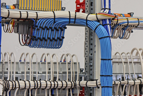 The reverse side of the electrical panel with connected wires with plastic ties.