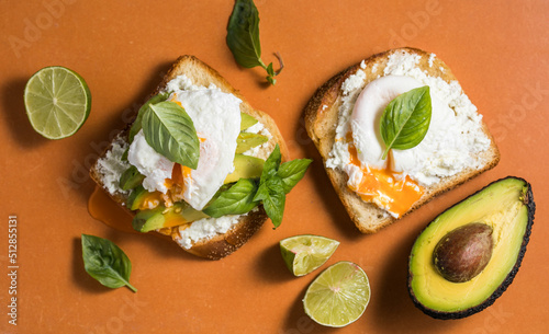 Breakfast concept - toast bread with sliced avocado, pouched egg