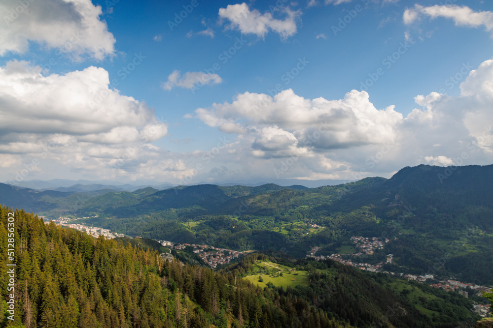 Mountain range of Rhodope Mountains covered with vegetation against the backdrop of valley covered with spruce forests
