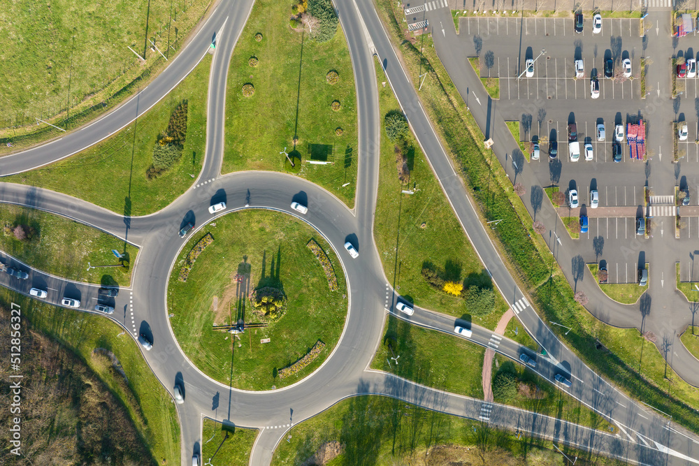 Leinwandbild Motiv - bilanol : Aerial view of road roundabout intersection with moving heavy traffic. Urban circular transportation crossroads