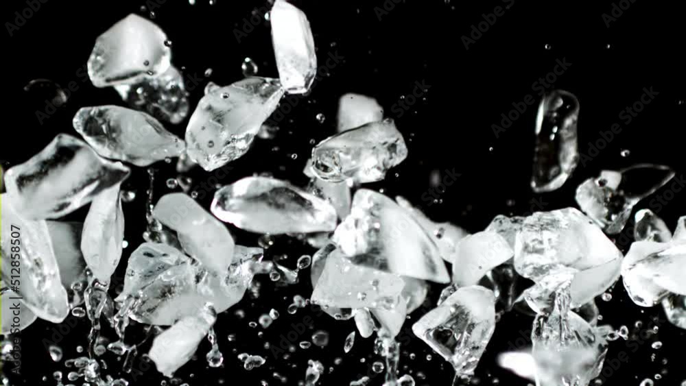 Pieces of ice rise up and fall down. On a black background. Filmed is slow motion 1000 fps.