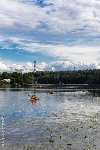 Moscow, Russia - June 18, 2022: double canoe with people floats on the river 