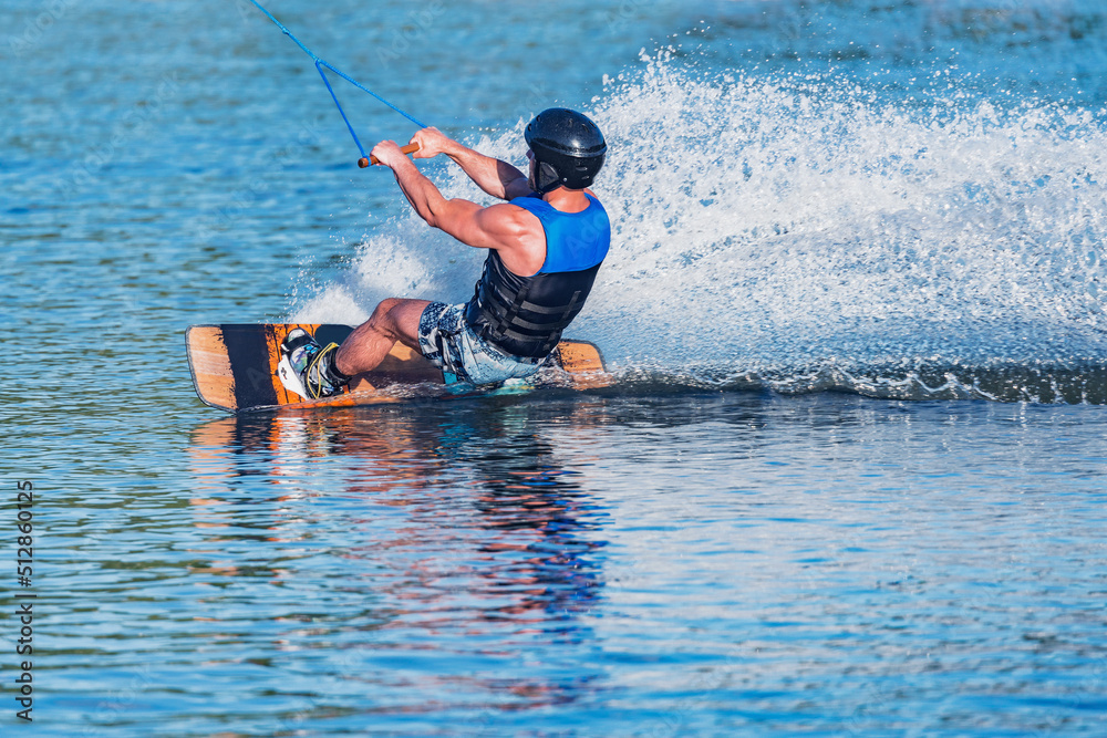 Fototapeta premium Kiteboarder enjoy surfing on the lake surface.